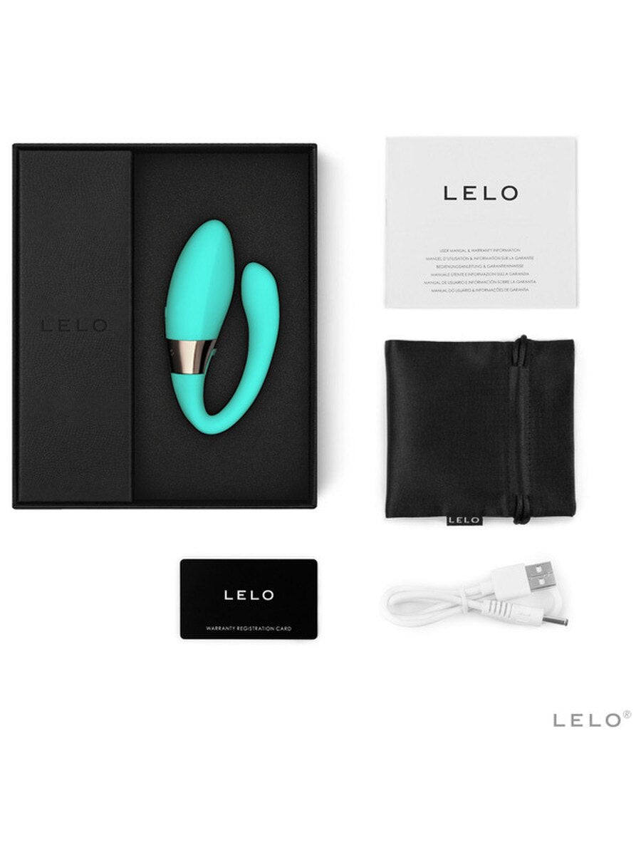 Turquoise electronic device with packaging and accessories on a white background