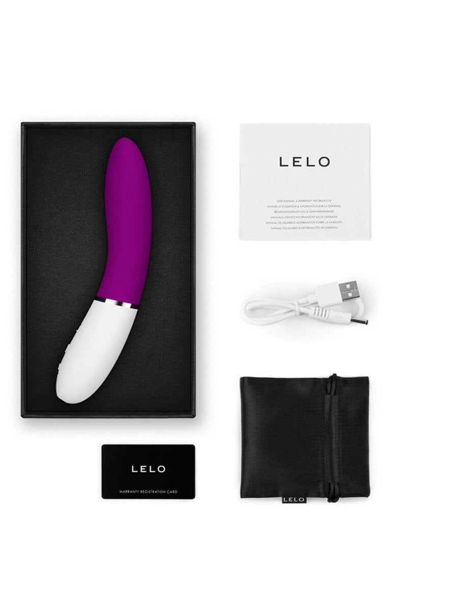 Purple and white LELO Liv 3 Vibrator  with packaging, USB cable, and pouch on a white background