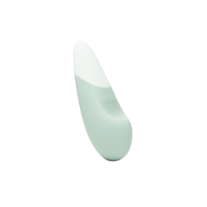 Close-up of a light green liquid droplet on a white background