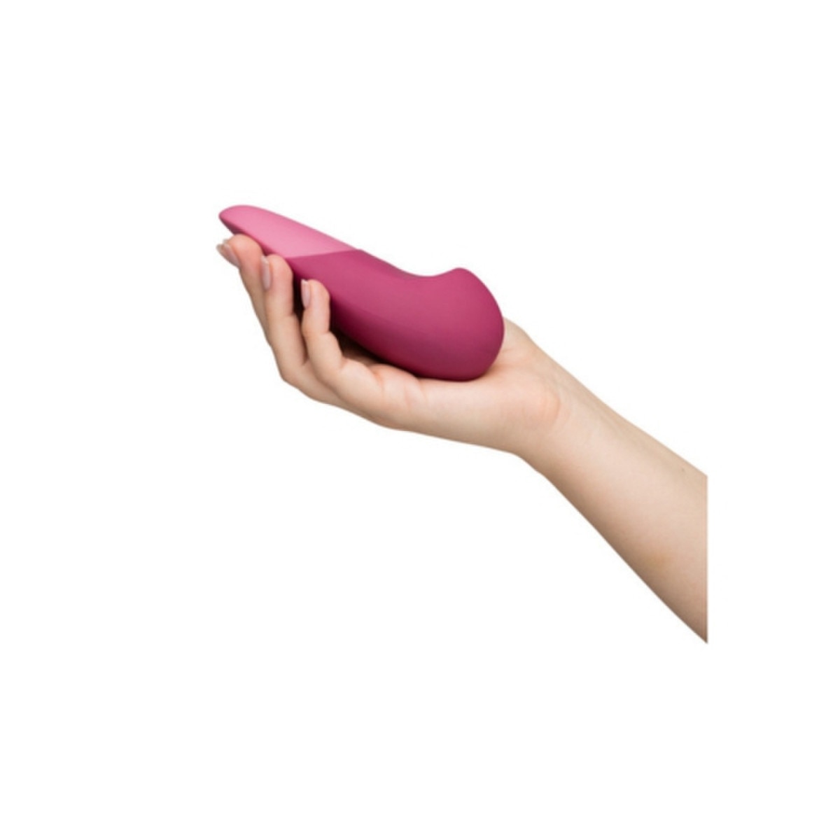 Hand holding a pink silicone Womanizer Vibe Massager on a white background