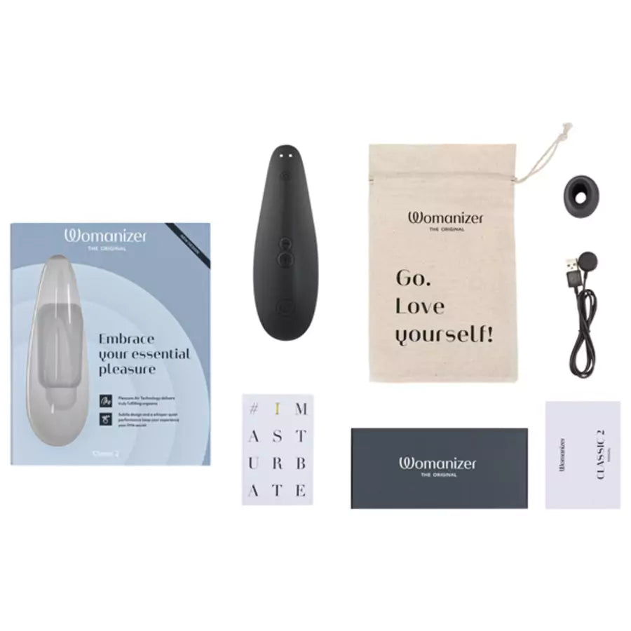 Womanizer Classic 2 Massager with packaging, remote control, and motivational pouch on a white background